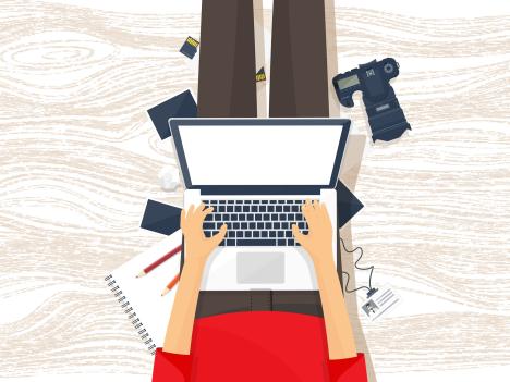 person editing video on laptop